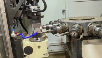Video cover showing multi-axis valve fitting machining in a CNC machining setup.